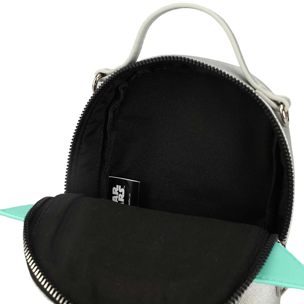Closeup view of the inside of a mini travel bags silver with a Grogu vinyl applique