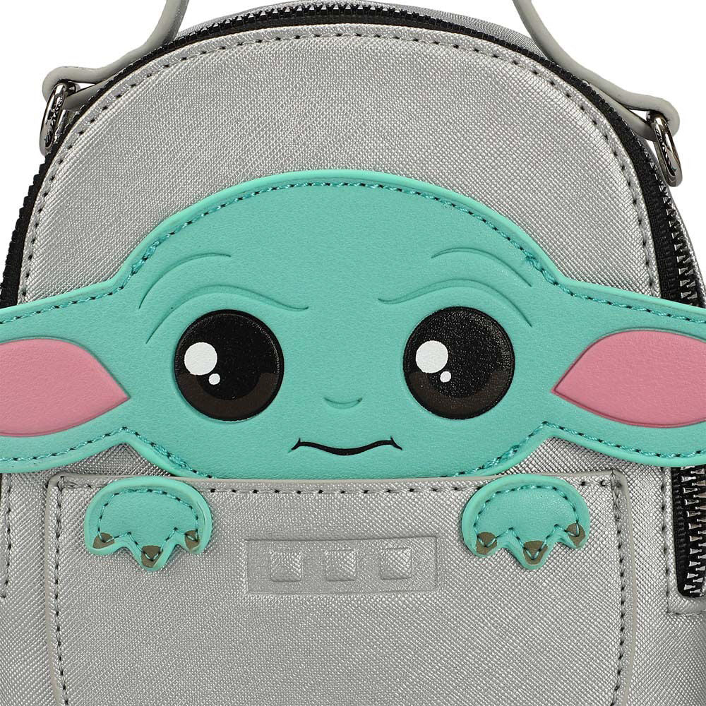 Closeup view of a mini travel bags silver with a Grogu vinyl applique